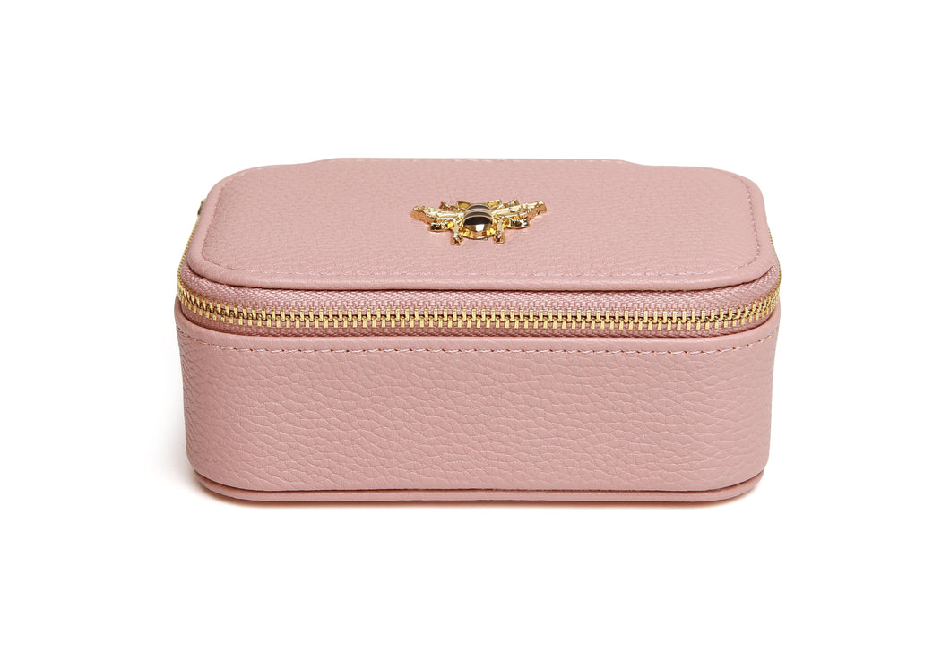 Pink jewellery box with a gold bee detail on the top and a gold zip detail