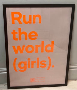 Framed "Run the world (girls)" print in neon orange on pastel pink