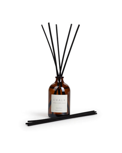 Neroli and Sweet Orange Reed Diffuser in an amber glass jar and black reeds