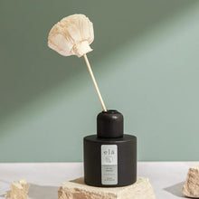 Load image into Gallery viewer, Beautiful flower hand cut from sola wood to create  a  room reed diffuser