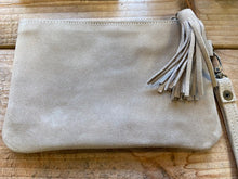 Load image into Gallery viewer, A clutch bag made in Morocco in genuine suede in a neutral colour. With an oversized tassel to the zip puller and a detachable wrist strap.
