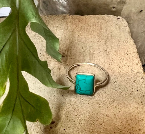 Nearly square turquoise stone ring in a delicate sterling silver setting