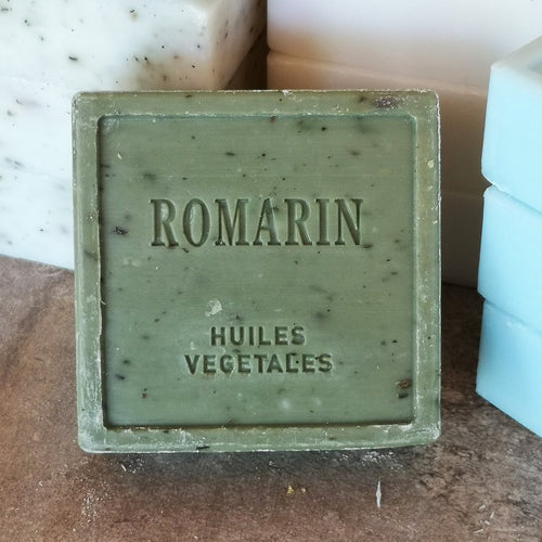 A  green block of rosemary scented soap 7.5x7.5x3cm 