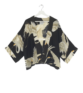 A kimono in black with beautiful images of storks in a range of off whites