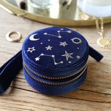 Load image into Gallery viewer, With a full zip closure to keep the contents safe and secure, inside this mini travel jewellery case are ring rolls, two small sections, and a pocket inside the lid to organise your small items of jewellery. In a navy blue velvet with a gold starry night design to the top. 