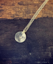 Load image into Gallery viewer, A sterling silver disc necklace with a pretty heart and radiating  dots emerging from it on a sterling silver chain.
