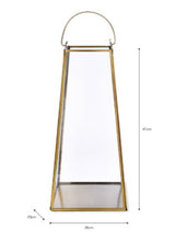 Load image into Gallery viewer, A large brass lantern. Delicate brass structure with glass sides. A moving handle to the top so it can be placed up or down. A flat base in brass to stand a pillar candle on. THe underneath has a black felt base so it can be stood on a table or on a fireplace hearth.