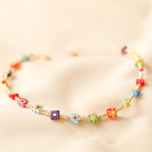 This beautiful ladies anklet features square millefiori beads in bright and bold colours with a mixture of ditsy floral designs, all separated by tiny round gold-plated beads. It has a lobster clasp to fasten and an extender chain that allows you to alter the size. 