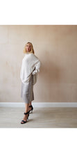 Load image into Gallery viewer, A luxurious 50% merino wool jumper with a funnel neck, loose fit and stunning side slits in a soft light oatmeal. 