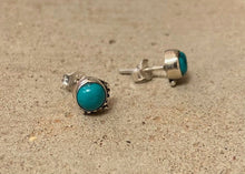 Load image into Gallery viewer, A turquoise stone encased and set in sterling silver 925. With a delicate filigree design to one edge of each earring. With a butterfly fastening to the back.