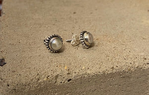 The pearl is encased in sterling silver, with a delicate design around the edge. These ladies earrings have a butterfly fastening to the back. 