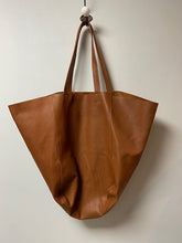 Load image into Gallery viewer, A beautiful tan leather handbag handmade in Marrakech. Morocco. It is a sizeable bag slouchy in nature. The inner leather ties can be secured to make the bag smaller, or keep them loose and the bag is large and spacious. With an inner zipped pocket and inner pockets. 