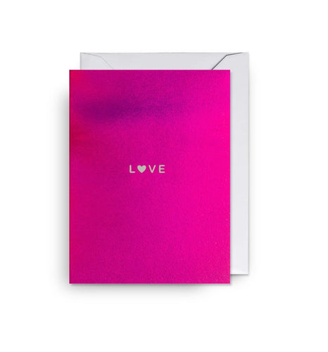 A metallic pink card with the word love in the centre of it.