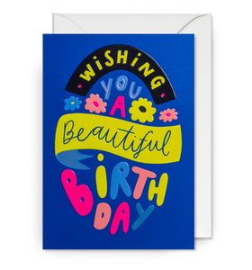 A royal blue card with the words Wishing You a Beautiful Birthday in bright lettering