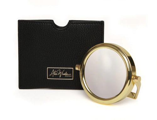 Small handbag mirror with two sides which magnify x1 and x7