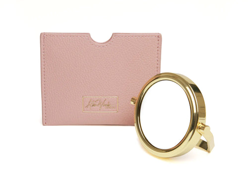Small gold handbag mirror with x7 magnification on one side and with a pink pouch to keep it safe