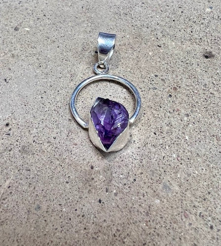 Spectacular deep purple amethyst on a circular sterling silver pendant