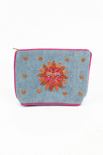 A simple rectangular purse with a brightly coloured bead sun face in orange, pink and gold