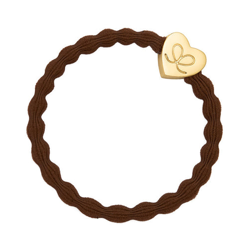 brown hair band with a gold charm