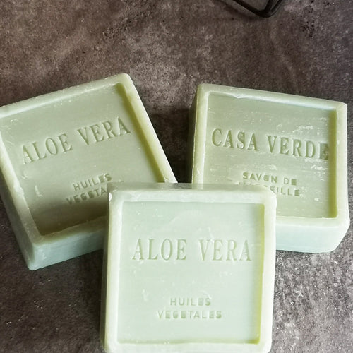 A square block of vegetable oil soap with the scent of aloe vera in a beautiful natural pale green colour