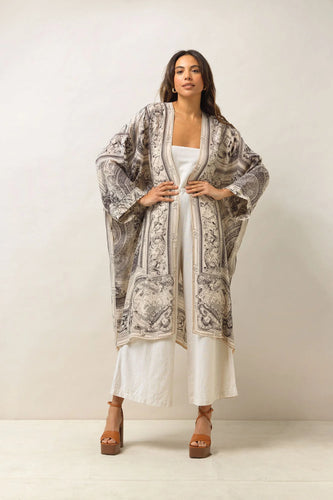 The cherub print grande kimono is below the knee with oversizes sleeves and side pockets. 