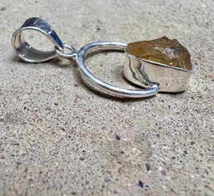 Citrine Stone In a Sterling Silver Setting On a Circular Pendant