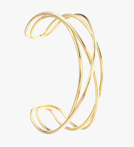 Criss cross cuff bracelet in 14 carat gold plate. Wear it to the beach, in the shower and wear it with perfume.