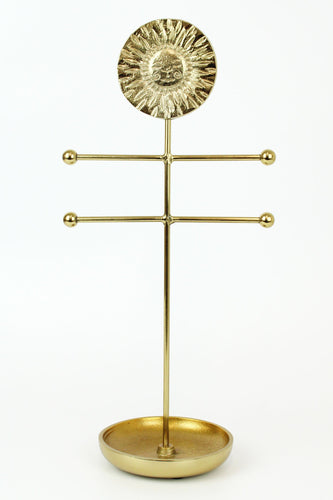 Heavy brass jewellery stand with a sun face and a ring dish at the base