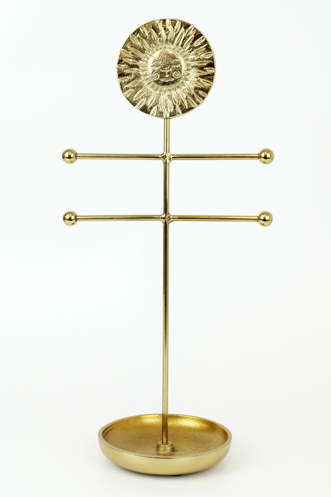 Heavy brass jewellery stand with a sun face and a ring dish at the base