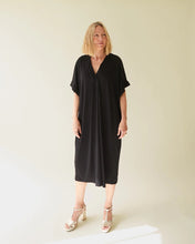 Load image into Gallery viewer, Black straight cut drape fabric dress with a v neck and sleeves that cover tops of arms