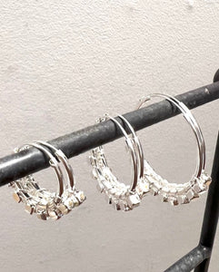 Three sizes of silver hoops with small block detail