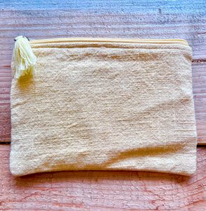 Pale yellow zip up pouch with lining and tassel zip