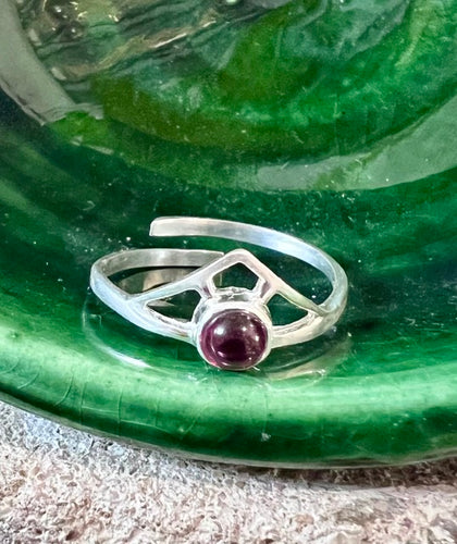 Garnet crystal - round with a sterling silver design ending in a point         
