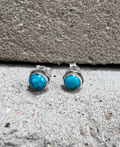 Small sterling silver studs with a round turquoise stone and a hexagonal surround