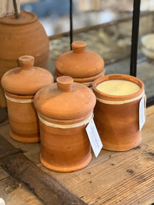 Moroccan rustic terracotta candles with lids. Each is filled with a citrus blend of essential oils and soy wax.