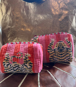 Small and large makeup bags with tiger print in a bright pink and red