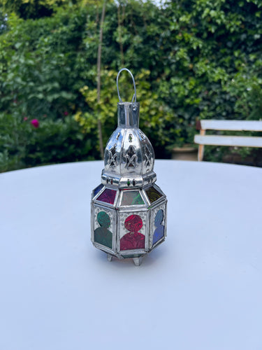 A Moroccan Lantern with Moroccan shaped windows in red, green, amber and blue