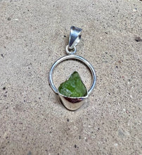 Load image into Gallery viewer, Green peridot crystal in a circular sterling silver setting