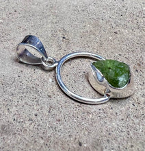 Load image into Gallery viewer, Green peridot crystal in a circular sterling silver setting