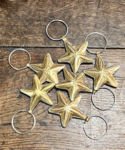 Load image into Gallery viewer, Collection of brass patterned keyring stars