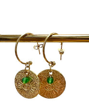 Load image into Gallery viewer, Evil eye disc earrings on hoops with a small green bead