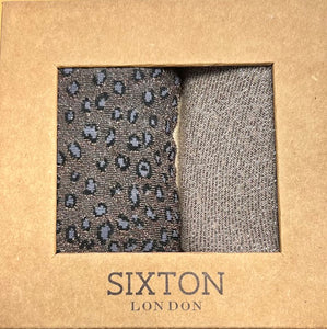 A sock box with brown glitzy leopard socks and some plain sand socks with glitter