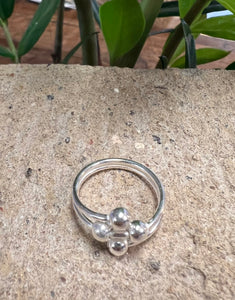 Sterling silver ring with four small spheres in the shape of a diamond