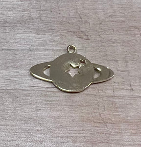 Saturn planet charm with cut out stars in plated gold