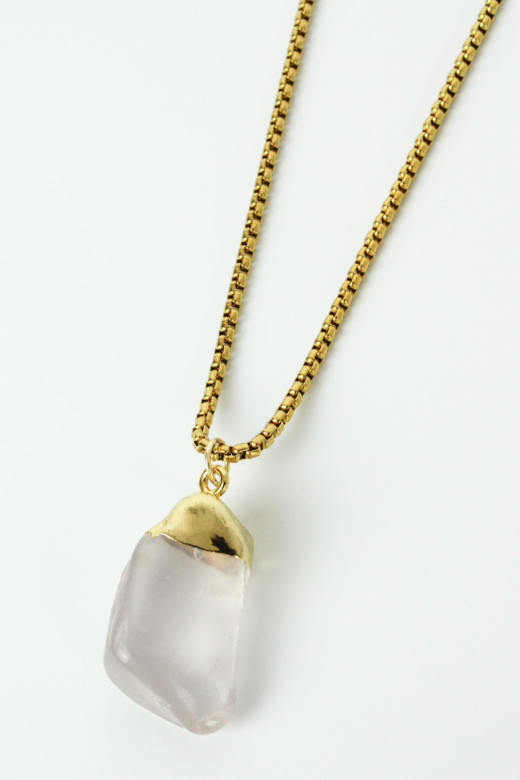 Rose quartz gem encased in gold with a gold chain necklace