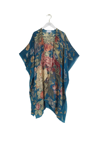 Stunning wool poncho with bright flowers on a teal background