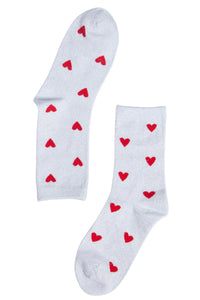 White glitter socks with small red hearts on them