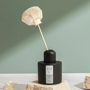 Beautiful flower hand cut from sola wood to create  a  room reed diffuser