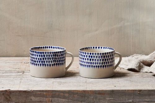 Nkuku Indigo Blue Drop Mug - a cream mug with handpainted blue drops