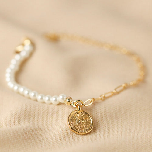Half pearl and half gold chain bracelet with a pretty circular talisman